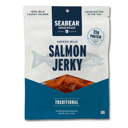 A 2.5 oz package of Seabear Smokehouse Smoked Wild Salmon Jerky, featuring a white and navy blue design with a fish graphic and a clear window showing the salmon jerky inside.