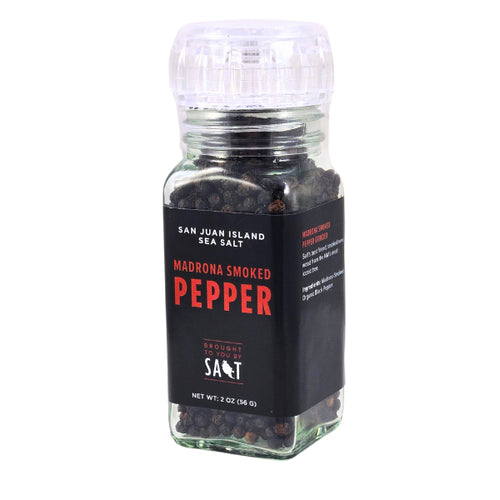 A clear acrylic grinder of San Juan Island Sea Salt Madrona Smoked Pepper, featuring a black label with red and white text, a clear ribbed top, and visible peppercorns inside, set against a plain white background.