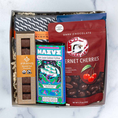 Chocolate Tasting Flight contents displayed in front of a white Made In Washington gift box.