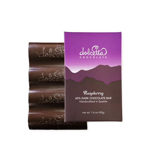 Dolcetta Chocolate 60% dark chocolate raspberry bar with packaging on a white background  | Dolcetta Dark Chocolate Raspberry Bars | Made In Washington | Sweet Treat For Candy Lovers