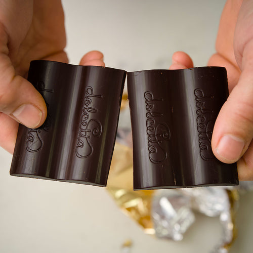 Dolceita Cacao Nib Crunch chocolate bar with packaging on a white background  |  Dolcetta Artisan Sweets | Made In Washington | Locally Made Chocolate Candy Bars