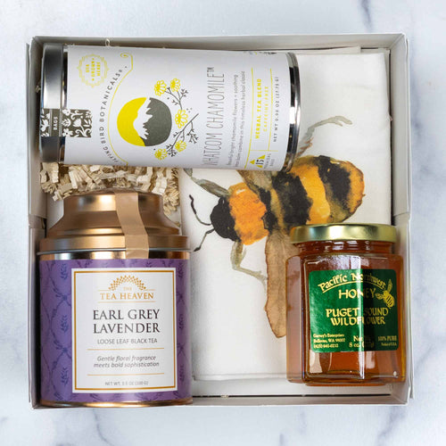 Two tea Cannisters, a jar of honey and bee tea towel arranged in front of a white gift box with the Made In Washington logo.