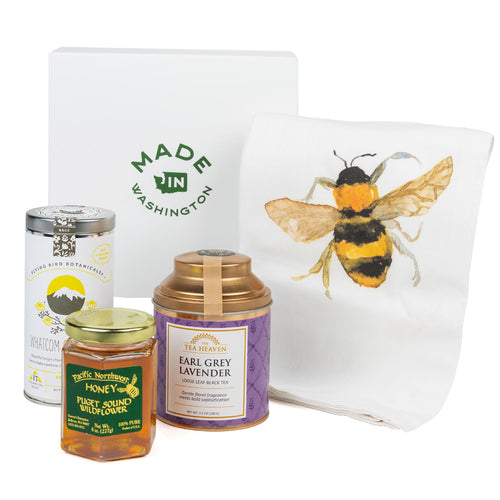 Two tea Cannisters, a jar of honey and bee tea towel arranged in front of a white gift box with the Made In Washington logo.