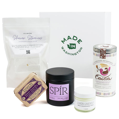 Collection of products including a candle, soap, and other items with branding on a white background | Lavender haze Gift Set | Made in Washington Gift Baskets | Local Gift Baskets