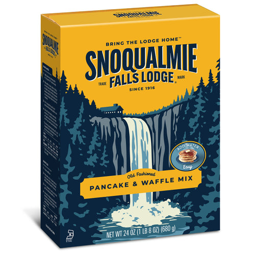 A box of Snoqualmie Falls Lodge Pancake & Waffle Mix, featuring a yellow and navy blue design with an illustration of a waterfall in a forest.