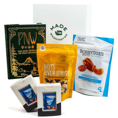 Assorted snacks and books with visible branding on a white background | Game Night PNW Style | Made In Washington | Friends Night Get Together | Stay In For Friends Night  | Gifts From The Pacific Northwest | Game Night Gift Basket