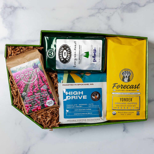 Collection of various coffee bags with different brands and designs on a white background | Coffees Across Washington Gift Box | Made In Washington | Local Gift Baskets for Coffee Lovers