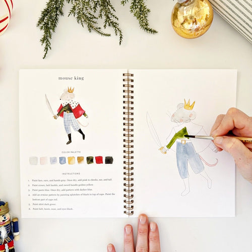 Watercolor workbook titled 'Nutcracker' with a decorative cover on a white surface | Emily Lex Nutcracker | Made In Washington Watercolor Workbook | Artist Gifts