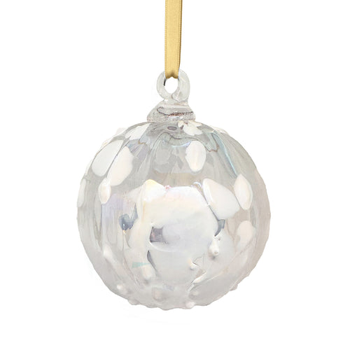 Hand holding a decorative glass ball with a floral design against a warm, blurred background. | 2025 Limited Edition Christmas Ornament | Made In Washington