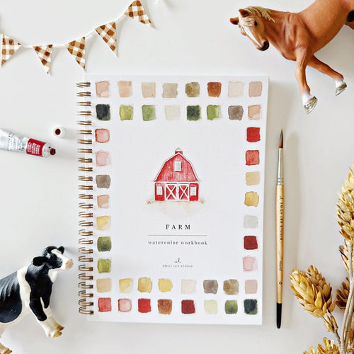 Color swatch workbook titled 'Farm' with a toy horse, cow, and paintbrush on a white surface. | Emily Lex Studio Farm Watercolor Workbook | Made In Washington | Gifts For Beginning Artists