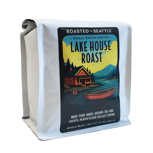 Coffee bag with 'Lake House Roast' label featuring a cabin and lake design. | Roasted In Seattle Lake House Roast Whole Bean Coffee | Made In Washington | Coffee Gifts From the PNW