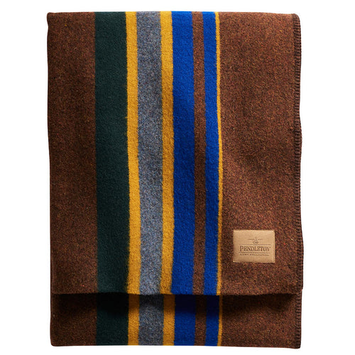 Folded blanket with striped pattern and Pendleton label on a white background | Pendleton Yakima Throw Camp Stripe Tobacco | Made In Washington | PNW Gifts