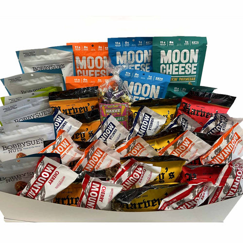 Assorted snack packages on a kitchen counter with shelves in the background | Made In Washington | Grab & Go Snacks for the the team | Shop Local Office Gifts