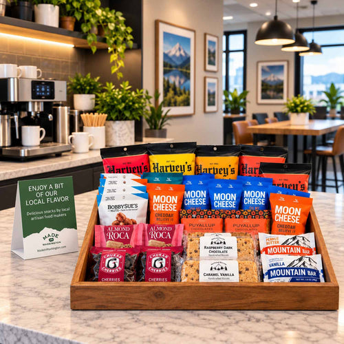 Artisan Grab and Go Snack Box tray filled with local snacks on a counter in a modern office breakroom.