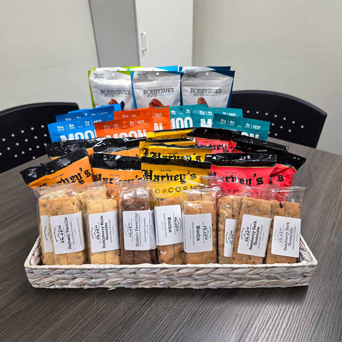 Assorted snack packages including cookies and chips in a basket on a table.