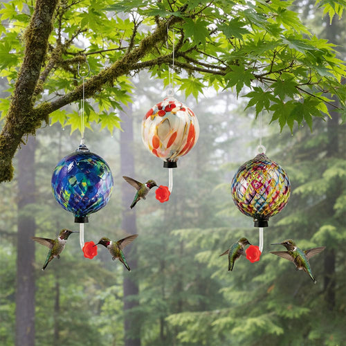 Colorful blown glass hummingbird feeder with a red flower-shaped feeding tube on a white background | Artisan Made By Glass Eye Studio | Made In Washington Gift stores