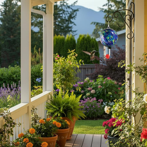 Colorful glass hummingbird feeder with a red base on a white background | Glass Eye Studio | Made In Washington Gift Stores