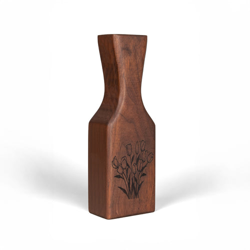 Sideview of handmade Wooden vase with floral engraving on a white background