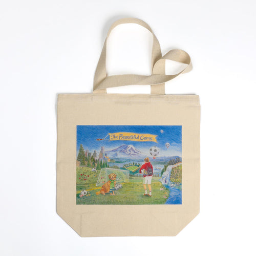 Canvas tote bag with a colorful graphic of a girl playing soccer in a park on a white background