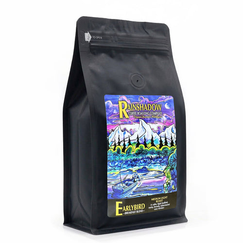 Earlybird Breakfast Blend black coffee bag with colorful label featuring mountains and trees on a white background