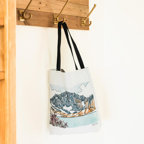 Summer in the Alpine tote bag featuring a mountain ridge and pink alpine wildflowers, designed by Port Angeles artist Amy Duffy