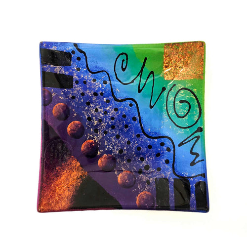 Square appetizer plate, colorful abstract Mardi Gras design on a white background
