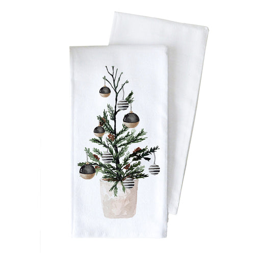 A white cotton kitchen towel with a watercolor illustration of a small Christmas tree in a pot with ornaments.