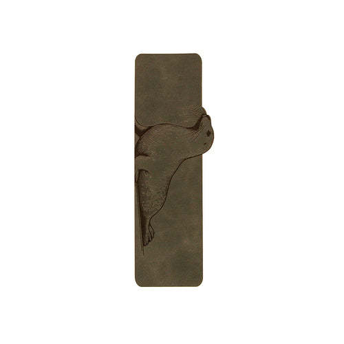 A rectangular dark grey bookmark featuring a raised relief carving of a harbor seal, shown against a solid white background.