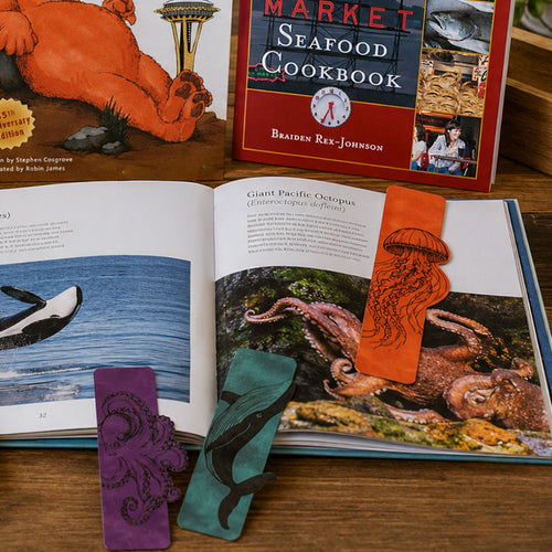 A topaz bookmark featuring a humpback whale silhouette illustration, centered on a plain white background.