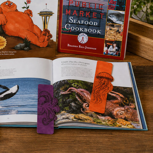 An orange bookmark featuring a black line art illustration of a jellyfish.