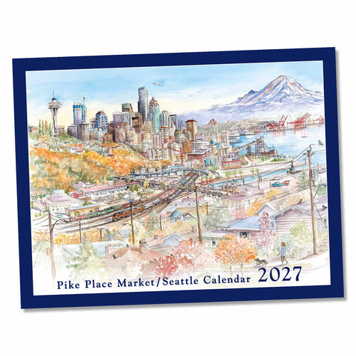 A square watercolor-style calendar cover for Pike Place Market / Seattle Calendar 2027, shown at a slight angle on a white background. The artwork depicts a Seattle cityscape with the Space Needle, skyline, waterfront, and Mount Raina.