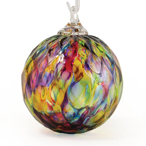 Multi-colored rainbow handblown glass ornament with diamond-faceted texture.