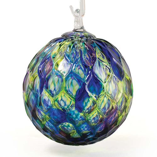 Ocean-blue and teal handblown glass round ornament with diamond-faceted surface texture.