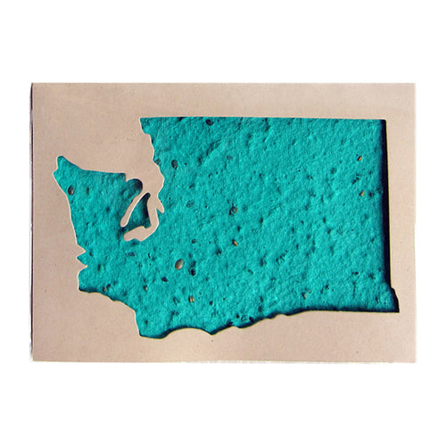 A plantable seed card featuring a turquoise blue textured shape resembling the state of Washington, beneath a cut out of the state in a light tan background.