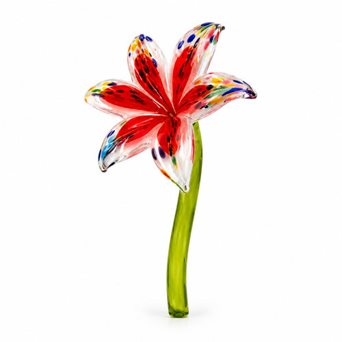 Hand-blown red glass lily flower with speckled multicolored petals on a green glass stem by Island Art Glass.