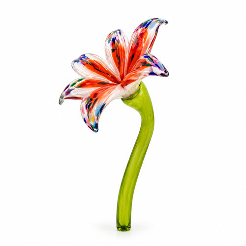 Low angle view of an orange speckled hand-blown glass lily flower on a green stem.