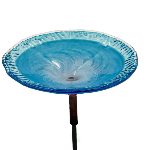Handmade turquoise art glass birdbath basin mounted on an outdoor metal stand.