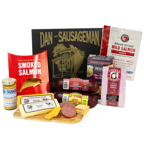 Assorted food products including SeaBear smoked salmon, cheese, and sausage chubs with 'Dan the Sausageman' branding. | Made In Washington State Gift Baskets | Dan The Sausageman Gift Box