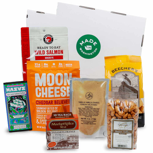 Assorted food products including Moon Cheese, Wild Salmon, and Beecher's on a white background | Bite Of Washington Gift Box | Made In Washington | Ready Made Local Gift Baskets