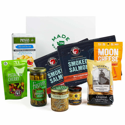 Assorted food products including smoked salmon, snacks, and pickled vegetables on a white background. | Smoked Salmon Charcuterie Box | Made In Washington | Local Grazing Box