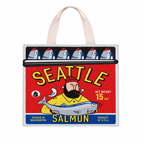A colorful Chalo shopping bag in a salmon can motif with a fisherman holding a salmon and canned salmon in in the rolled back tin on white background.