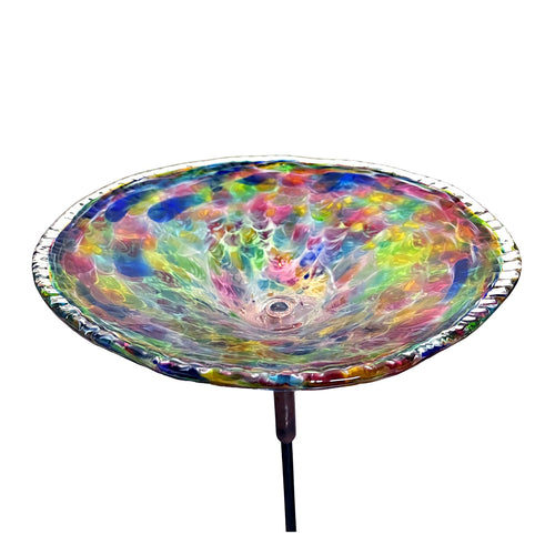 Colorful  blown glass birdbath on a white background.