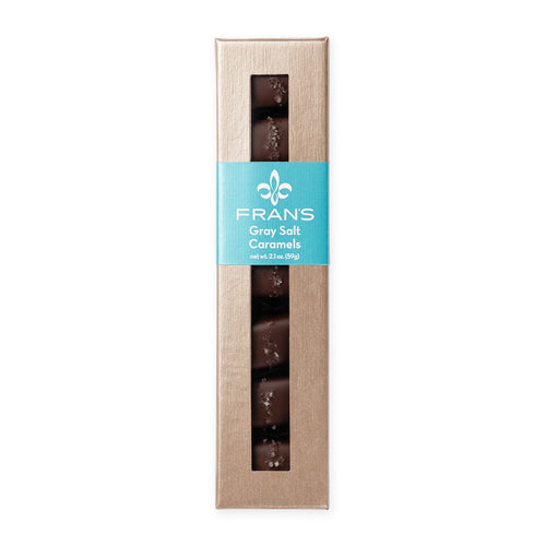 A box of Frans Gray Salt Caramels in a tall champagne colored package with a turquoise label, shown on a plain white background.