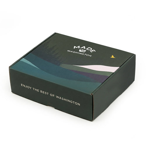 Closed dark green Made In Washington gift box with the Colors of Washington  landscape rendition artwork lid.