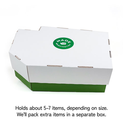 White Washington State shaped box with green bottom and 'Made in Washington' label on a white background | Design Your Own Gift Basket in a state shaped box | Local Gift Baskets